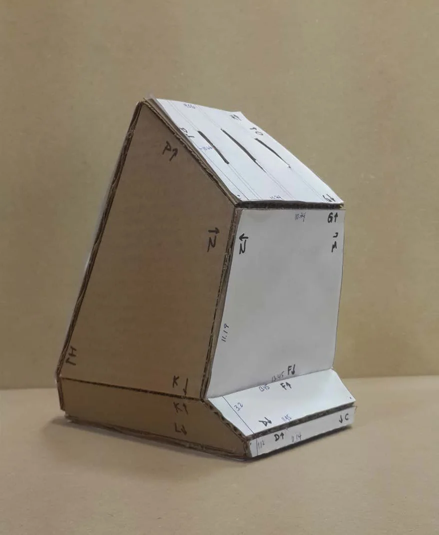 Cardboard model of the knife block, its panels labeled in marker