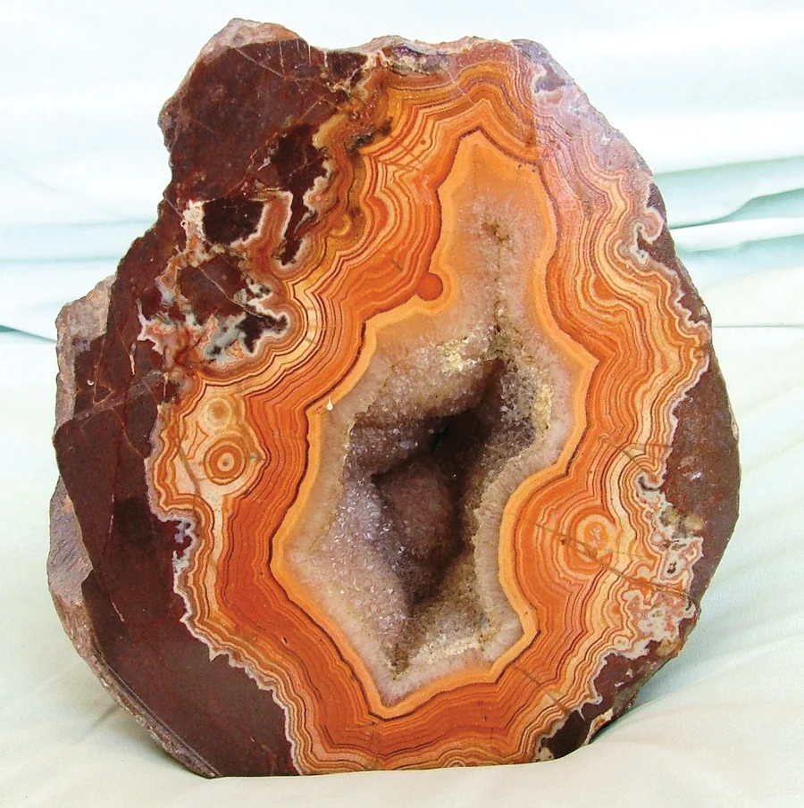 Moodboard reference: agate geode, banded orange stone around a crystal core