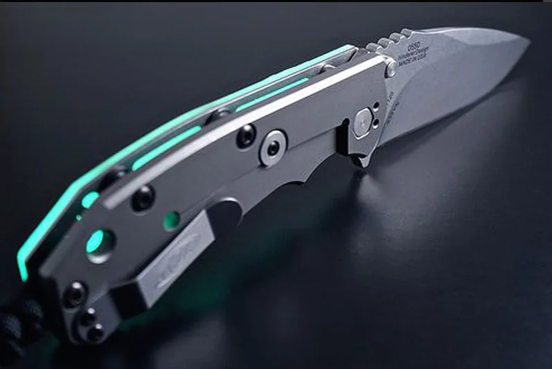 Moodboard reference: folding knife with glowing teal edges on black