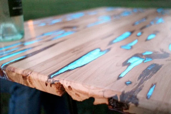 Moodboard reference: table of split wood filled with glowing turquoise resin