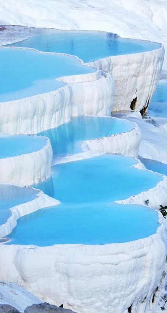 Moodboard reference: white mineral terraces holding turquoise water
