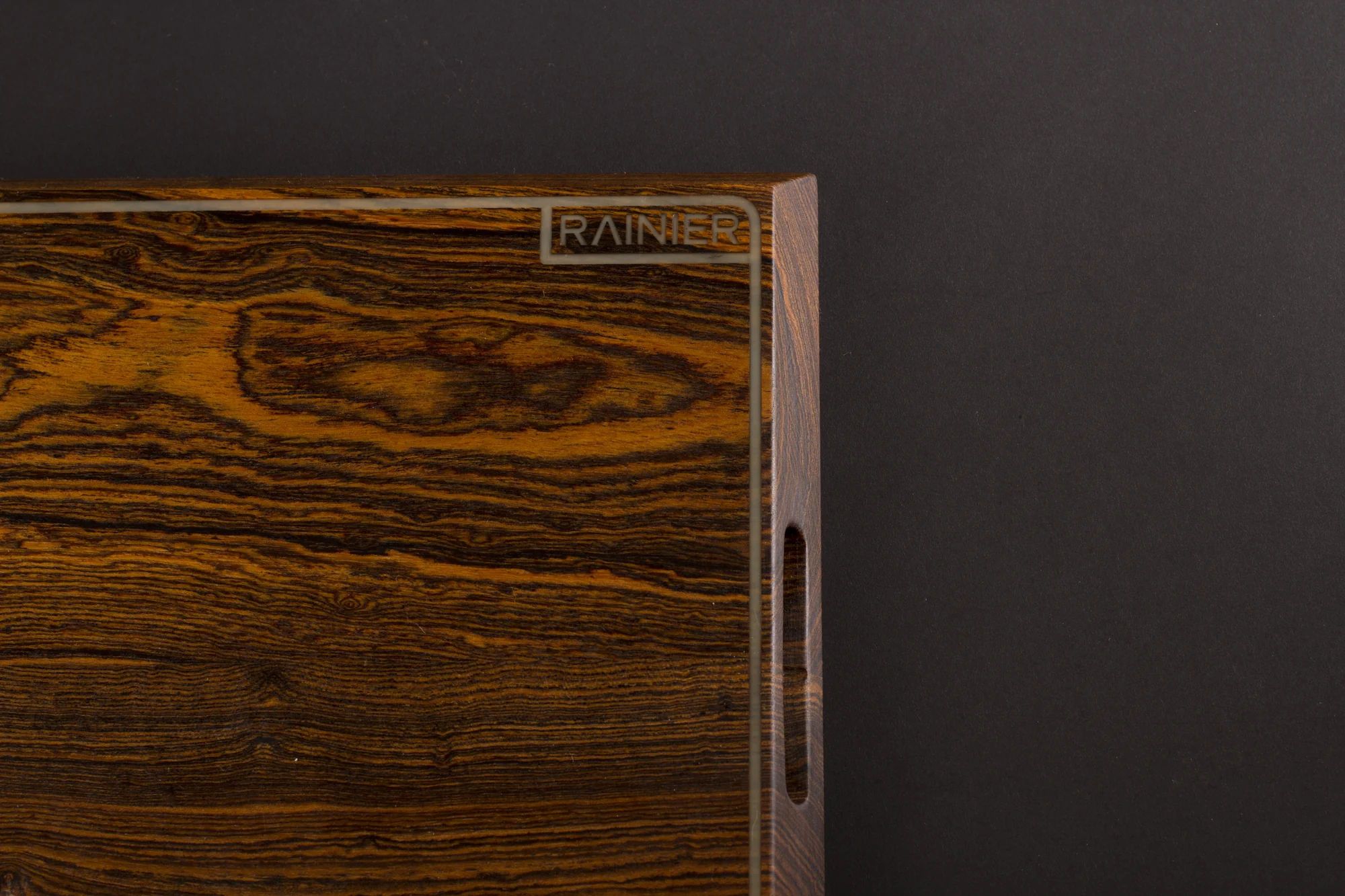 The board on edge, the inlaid Rainier logotype catching the light