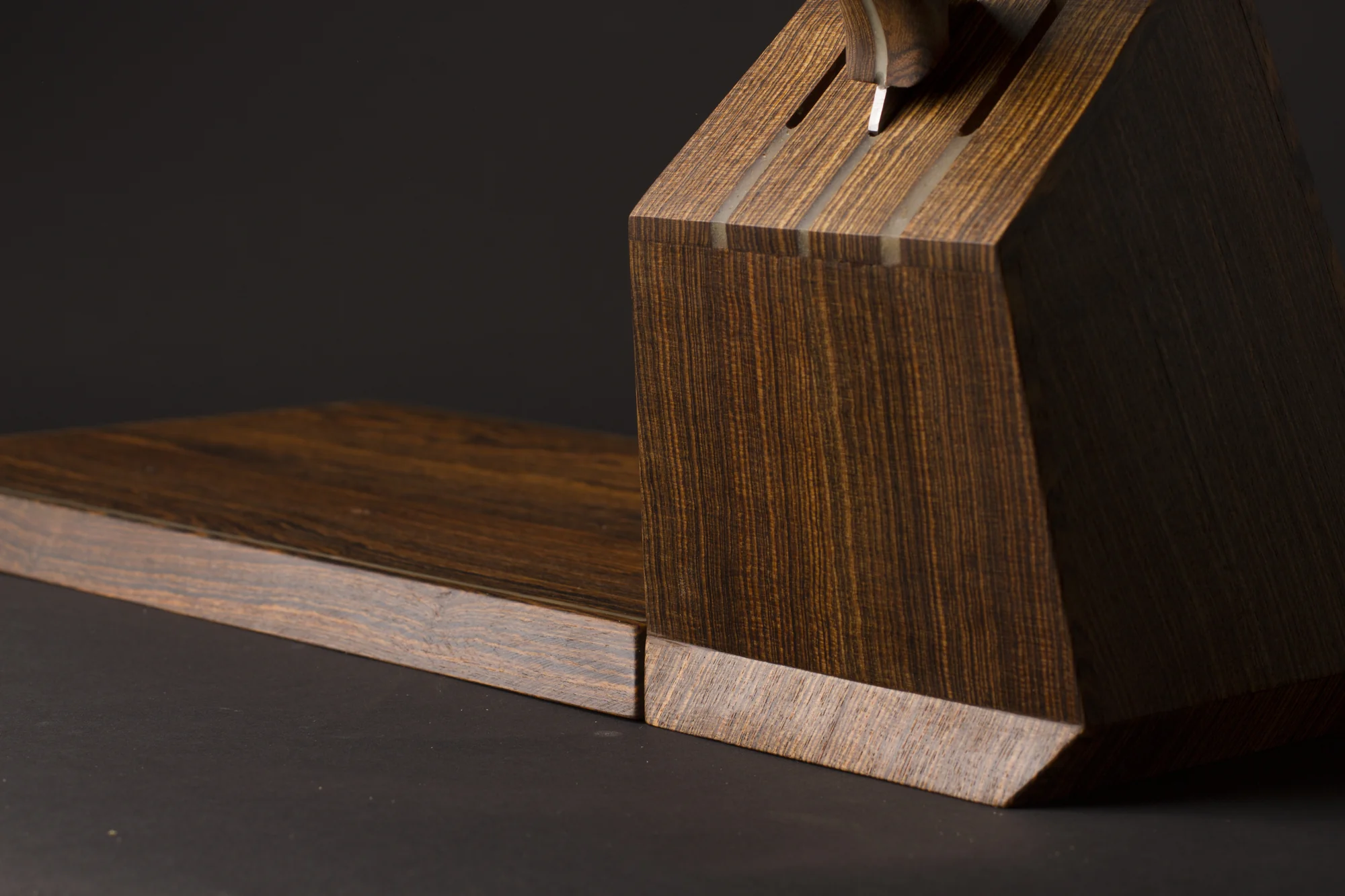 Side close-up of the knife resting against the block on the board