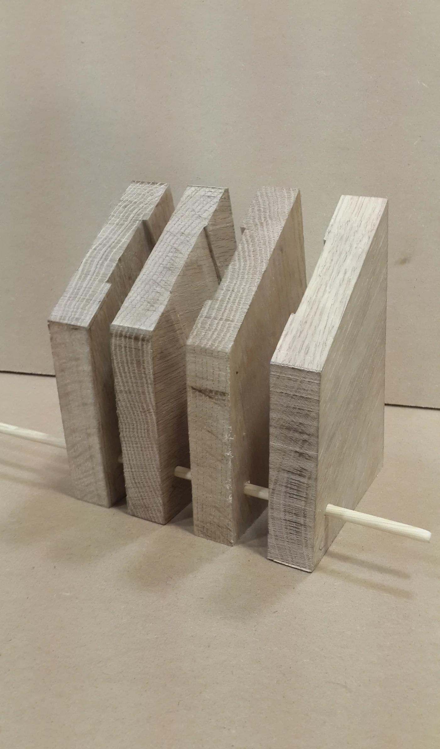 The knife block mid-lamination: slotted wood slices threaded on a dowel