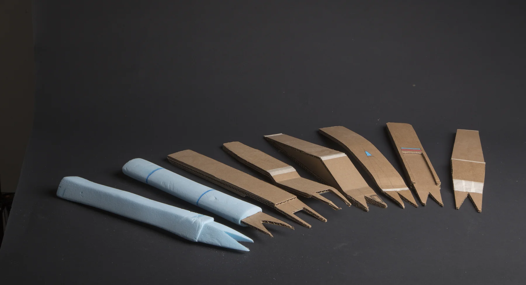 Lineup of ten carved handle prototypes